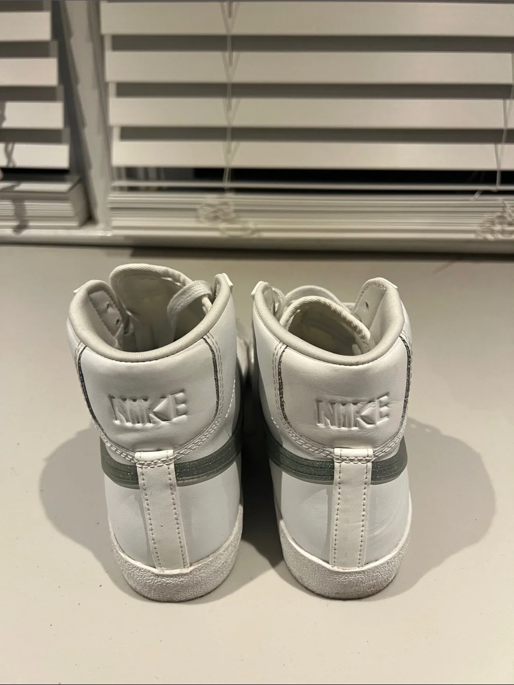 Nike White High-Top Sneakers with Green Swoosh Accent